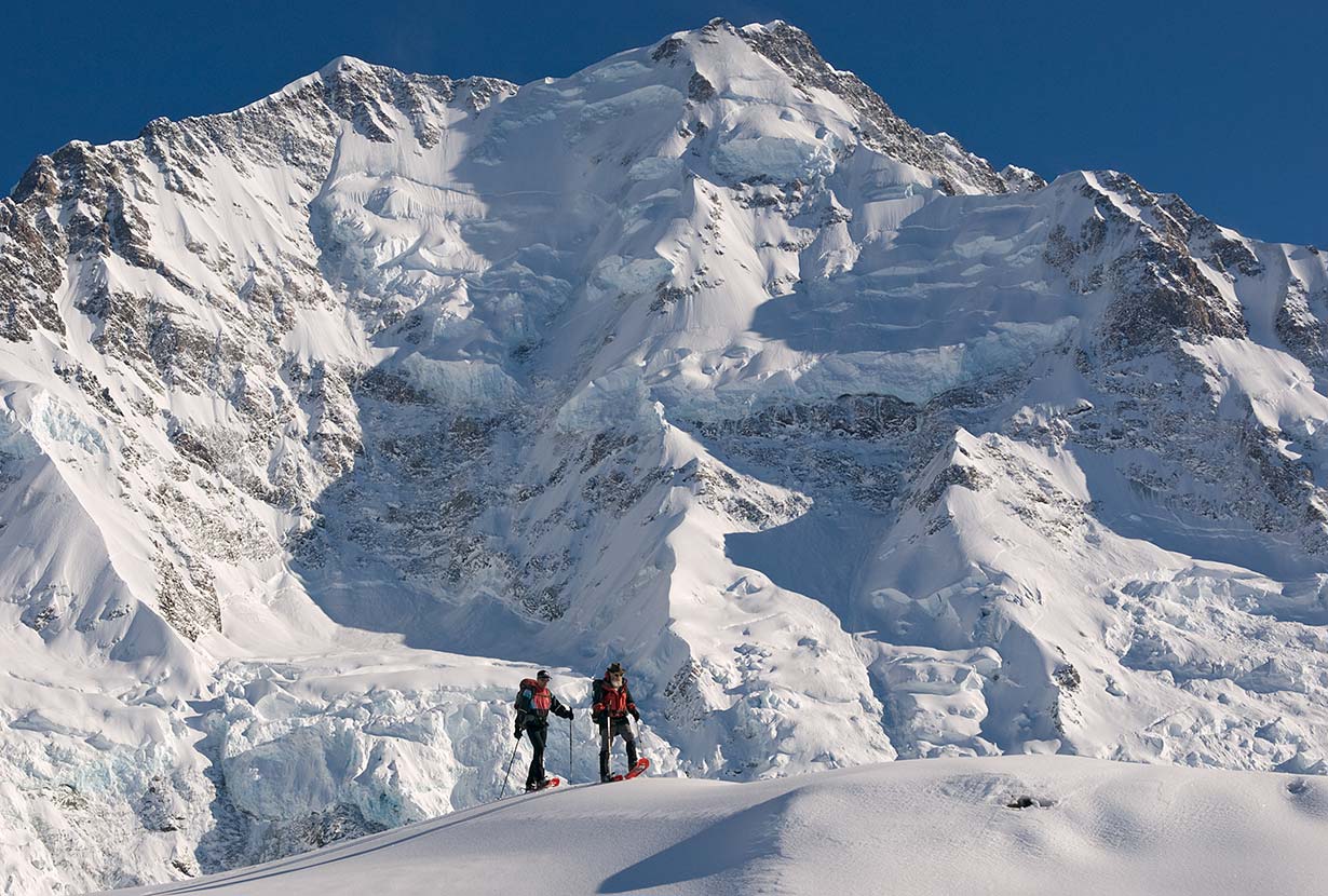 Snowshoers on Ball Ridge, in front of the Caroline Face of Aoraki / Mt. Cook