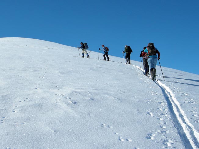 Nordic skiers above Rex Simpson Hut