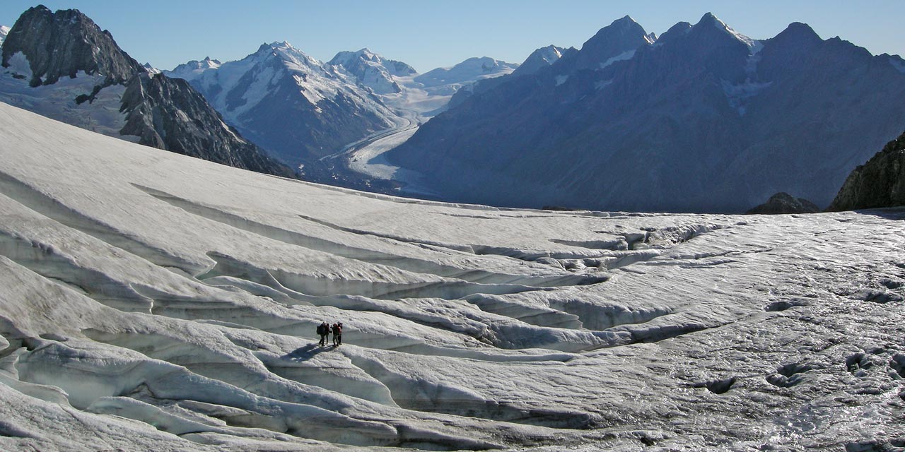 Group of trekkers exploring Ball Glacier crevasses